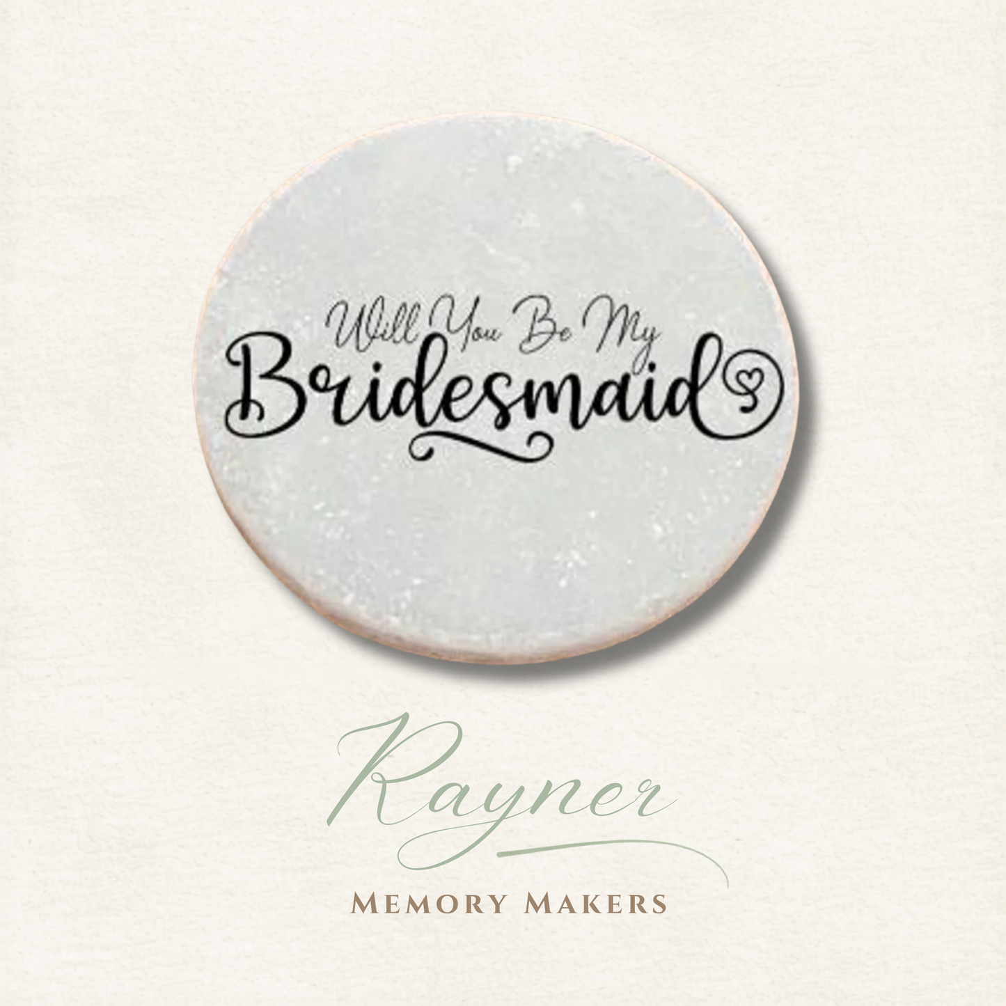 Round pebble with 'Will You Be My Bridesmaid' text on a light background