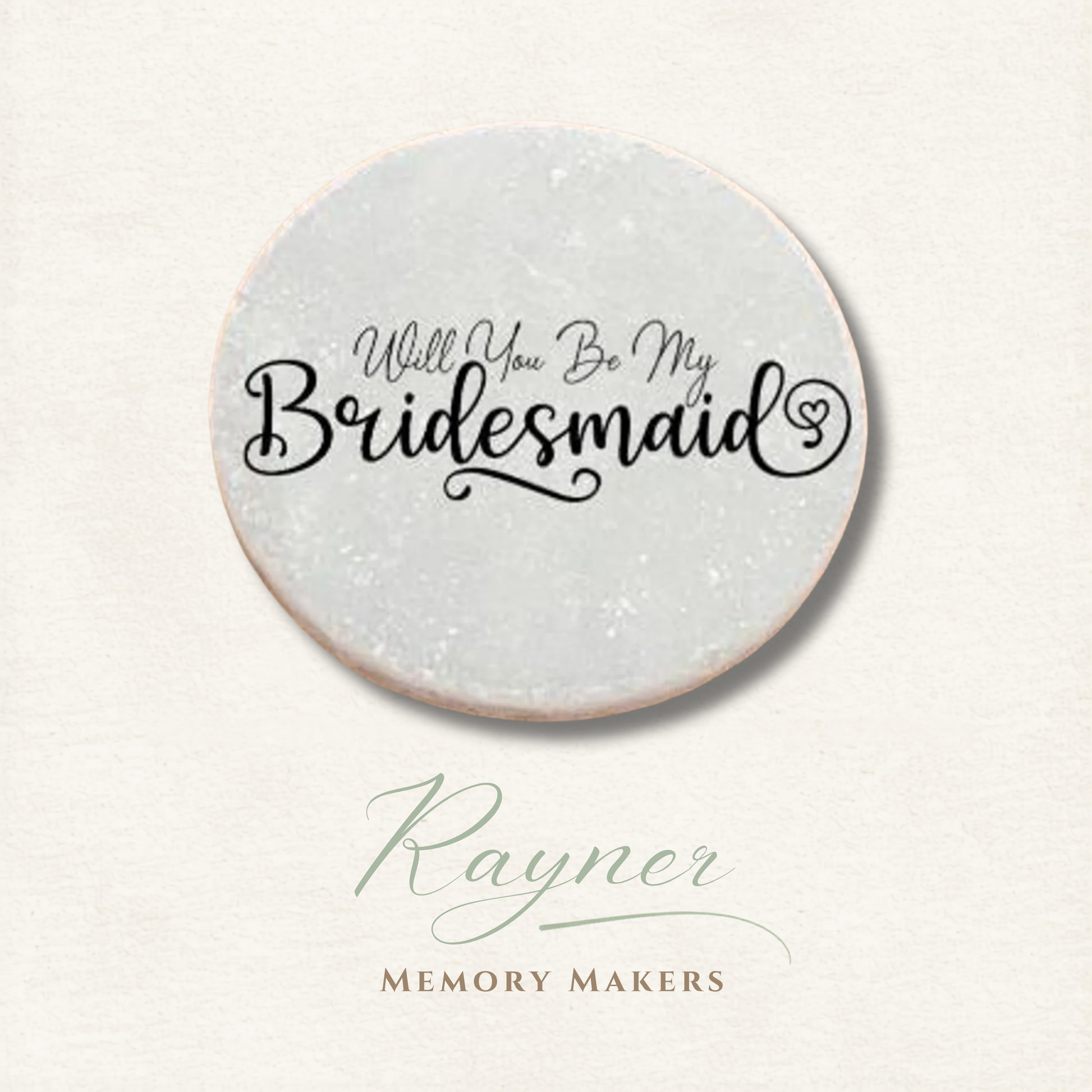 Round pebble with 'Will You Be My Bridesmaid' text on a light background