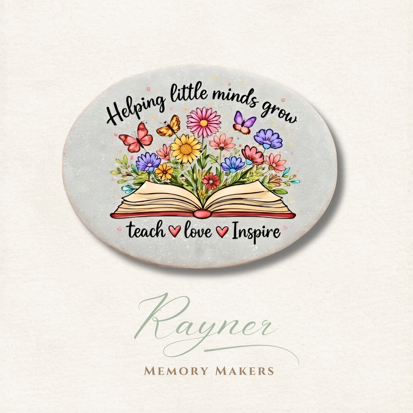 Round ceramic coaster with colorful flowers, book, and text 'Helping little minds grow, teach love inspire' on a light background.